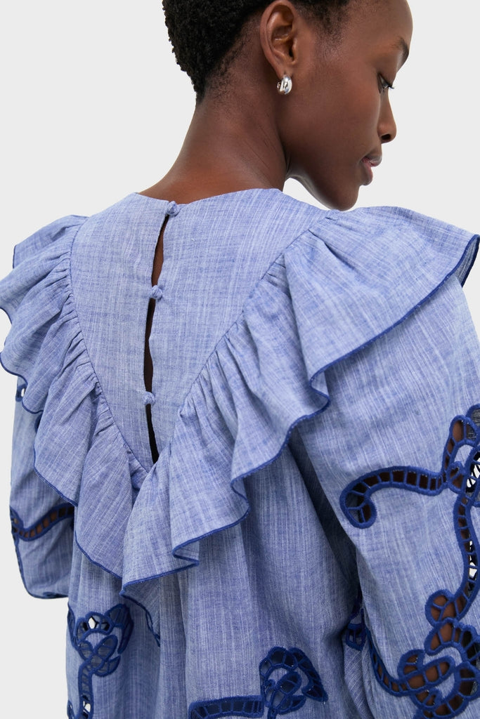 Back and side view of the Seabank Chambray Azalea Dress, showcasing its classic, high-end design with ruffled shoulders, open-work embroidery, and a deep V-back with buttons.