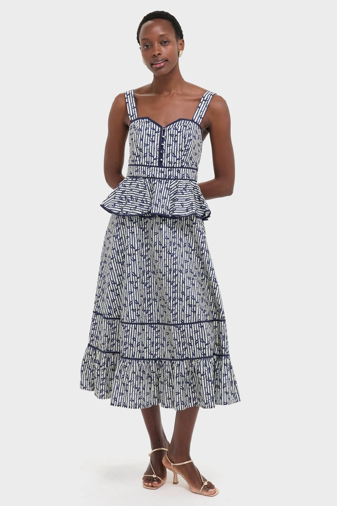 Model in the Vine Stripe Lacey Dress, featuring a classic, effortless design with a fitted bodice, peplum waist, and tiered skirt, embodying Tuckernuck's fun, high-end style.