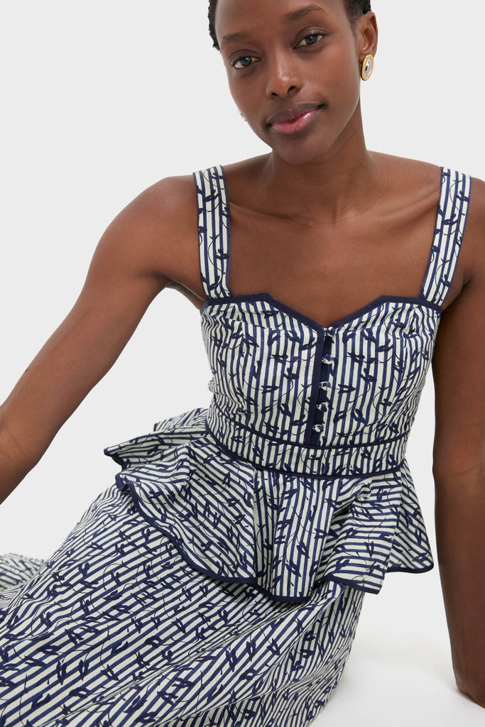 Model wearing the Vine Stripe Lacey Dress with a sweetheart neckline and peplum style, exuding classic and effortless high-end fashion.