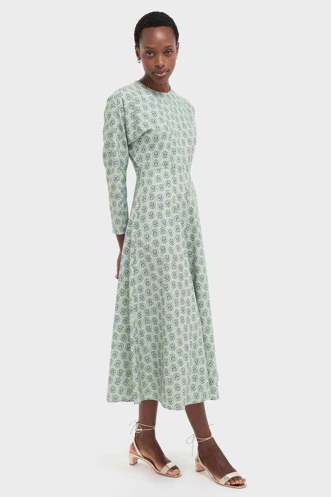 Model wearing the Navy Bird Block Vika Dress, a classic, effortless maxi with a floral motif, paired with fun metallic sandals, embodying Tuckernuck's high-end style.