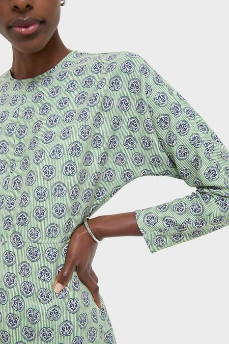 Model wearing the Navy Bird Block Vika Dress, featuring a classic light green design with navy-and-white motifs, three-quarter sleeves, and a modest neckline; an effortless, high-end choice.