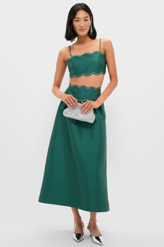 Model wearing Crystal Rue Earrings with an emerald two-piece set, silver clutch, and slingback pumps. The earrings add a classic, high-end touch, perfect for an effortless, fun evening look.