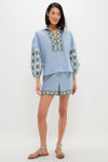 Model wears classic Sky Geometric Embroidered Parish Shorts with matching blouse, showcasing effortless high-end style and fun geometric embroidery, ideal for warm-weather destinations.