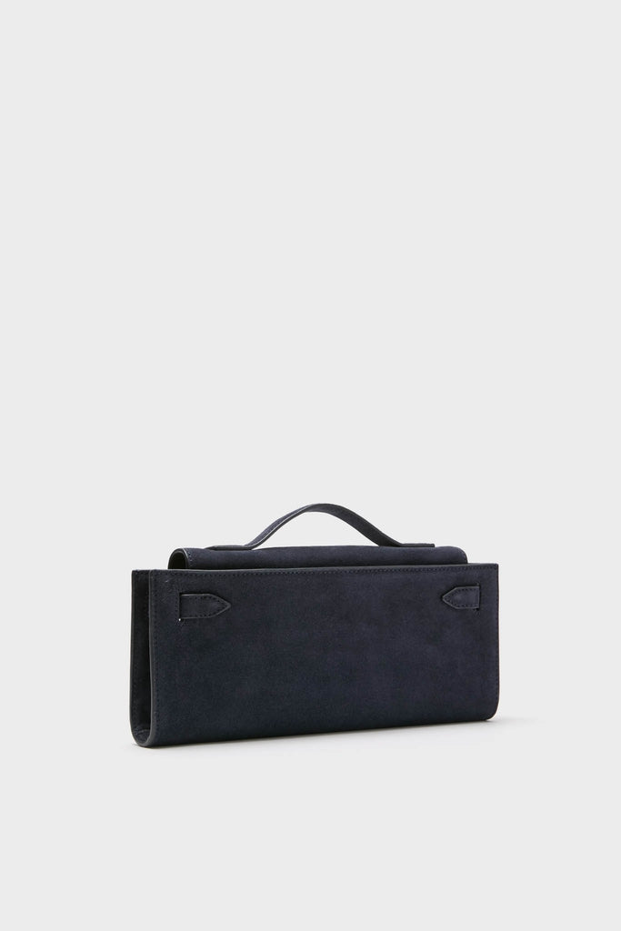 Navy Suede Veronica Beard Dash Clutch: A classic, high-end handbag with an effortless and minimalist design, featuring a slim rectangular shape and a short top handle.