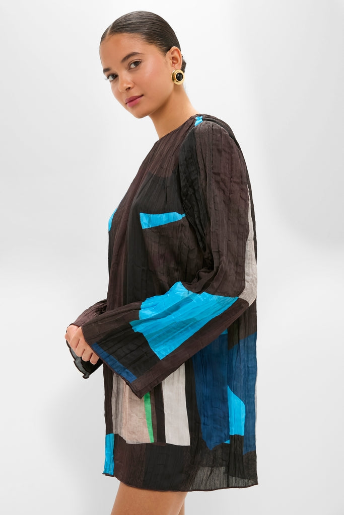 Woman models the Blue Prism Kona Dress, a classic, effortless mini with abstract prints, long sleeves, and a straight silhouette, embodying high-end, fun style.