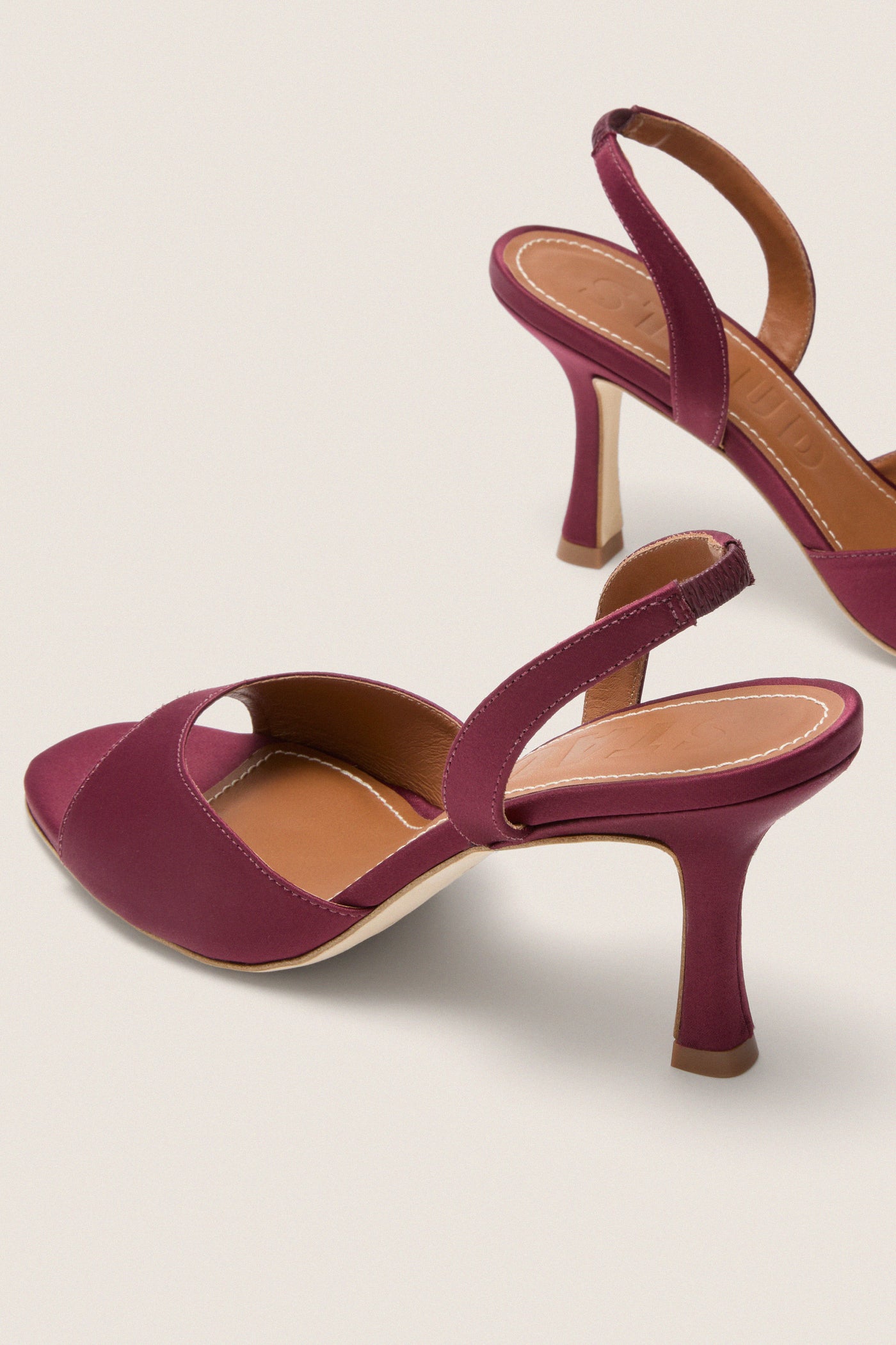 Mulberry Brigitte Heel: Classic sling-back sandals in rich burgundy satin, featuring an open toe and slender stiletto heel, embodying an effortless, fun, high-end style.