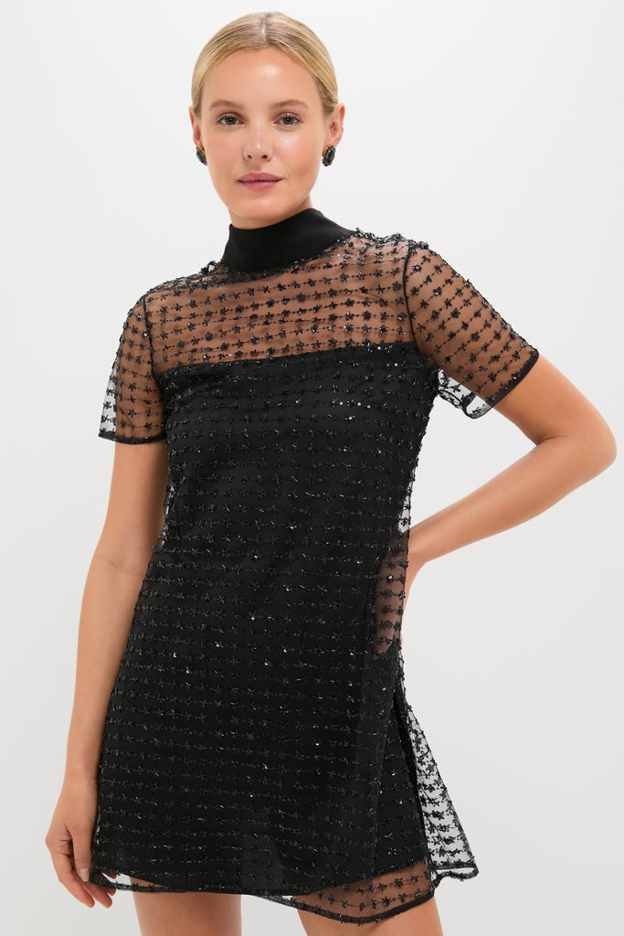 Stardust Onyx Ilana Dress: A classic, high-end mini with effortless charm, featuring a mock neck, sheer embellished tulle overlay, and self-tie bow. Perfect for festive fun.