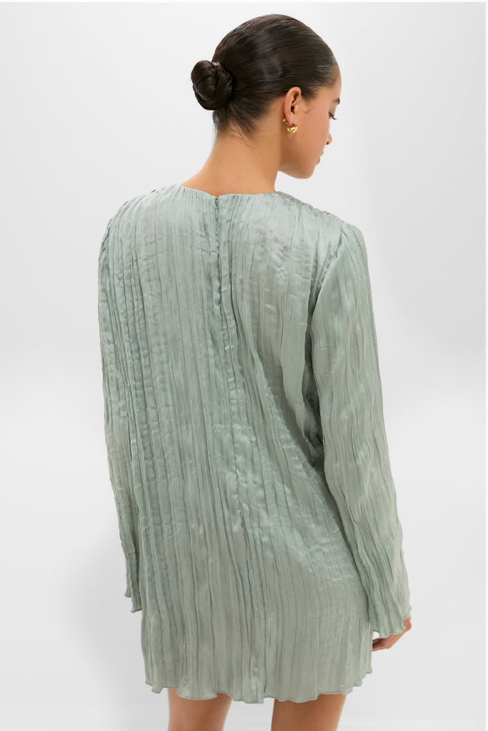 Woman in a classic, high-end Silver Sage Kona Dress with crinkle pleats and a straight silhouette, showcasing an effortless and fun style.