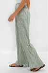 Silver Sage Nami Pant: Effortless, high-end wide-leg pants with pleated detail and elastic waistband, paired with classic black sandals for a fun, relaxed look.