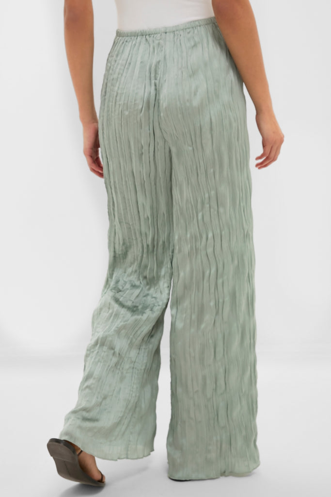 Silver Sage Nami Pant, classic and effortless, features pleated detail and an elastic waistband, styled with a white top and sandals for a fun, high-end look.