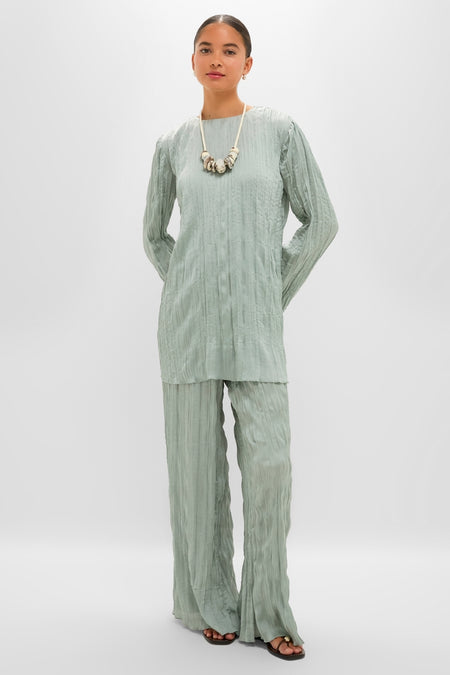 Woman in a classic, effortless Silver Sage Nami Pant and matching tunic, accessorized with a chunky necklace, embodying a high-end, fun style.