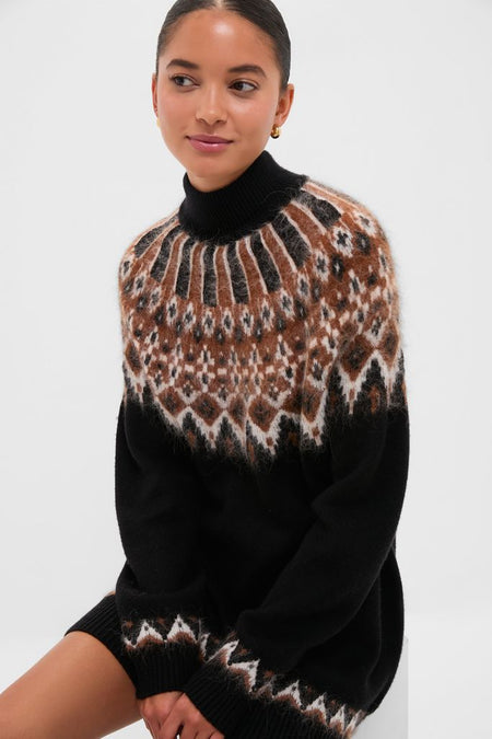 Young woman wears the Zermatt Liza Sweater Dress, a classic black turtleneck with an effortless fair-isle pattern, embodying a fun, high-end style.
