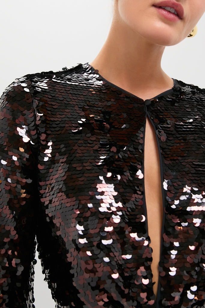 Woman wearing the Espresso and Black Fifi Dress, a classic and high-end sequin-covered garment with an effortless, fun style, fastened at the throat, revealing a V-shaped neckline.