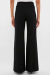 Model in classic, black Kalinda Pant; high-waisted, wide-leg, with a polished pressed crease. Effortless, high-end style perfect for both work and fun outings.