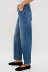 Rebel Blue Harley High Rise Arc Leg jeans with a classic, effortless silhouette featuring a high-rise waist and barrel leg, paired with black slip-on flats.