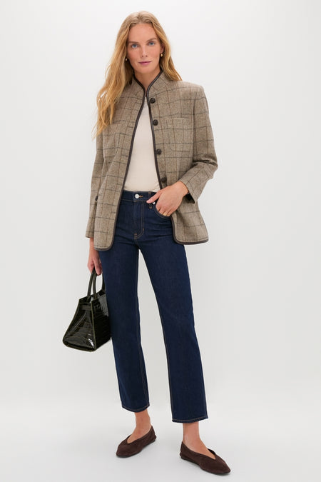 Woman wearing Indigo Rinse Leah Mid Rise Straight Leg jeans, styled with a windowpane-check blazer and cream top, exudes a classic, effortless, high-end look with a fun twist.