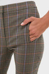 Hand in pocket of classic Russet Multi Arte Pant, showcasing high-end slim-fit, checked plaid in muted tones with an effortless tailored style and fun flared hem.