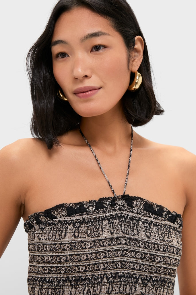Woman wearing the Black Multi Ayanna Dress, featuring a strapless, smocked design with a paisley print and narrow halter strap, paired with large, gold hoop earrings for an effortless, high-end look.