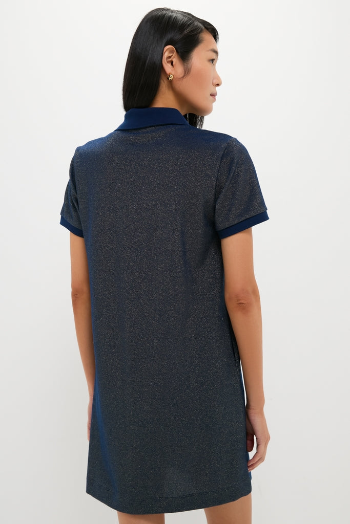 Woman in a classic, effortless Navy Gold Lurex Pique Hutton Dress, showcasing a fun, high-end style, with a subtle metallic finish and a hint of gold hoop earring.