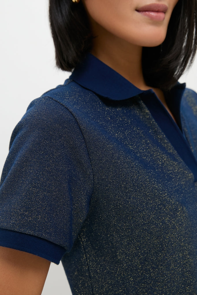 Woman wearing Navy Gold Lurex Pique Hutton Dress, a classic, short-sleeved navy polo with elegant gold threads, exuding an effortless and high-end sparkle.
