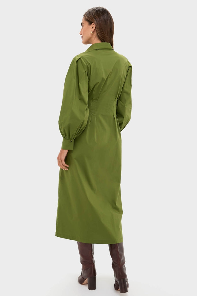 Model wearing the Fern Corinne Dress, a classic olive-green shirt-style dress with full-length bishop sleeves, paired with knee-high leather boots for an effortless, high-end look.