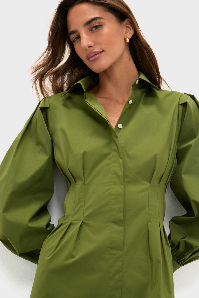 Model wearing the Fern Corinne Dress, a classic and high-end olive-green shirt-dress with an effortless, tailored fit, embodying a fun, modern elegance.