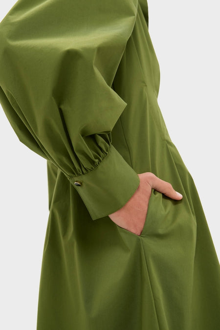 Fern Corinne Dress: A classic, high-end piece with an effortless style, featuring a smooth, structured fabric, side seam pocket, and buttoned cuff for a fun, confident look.