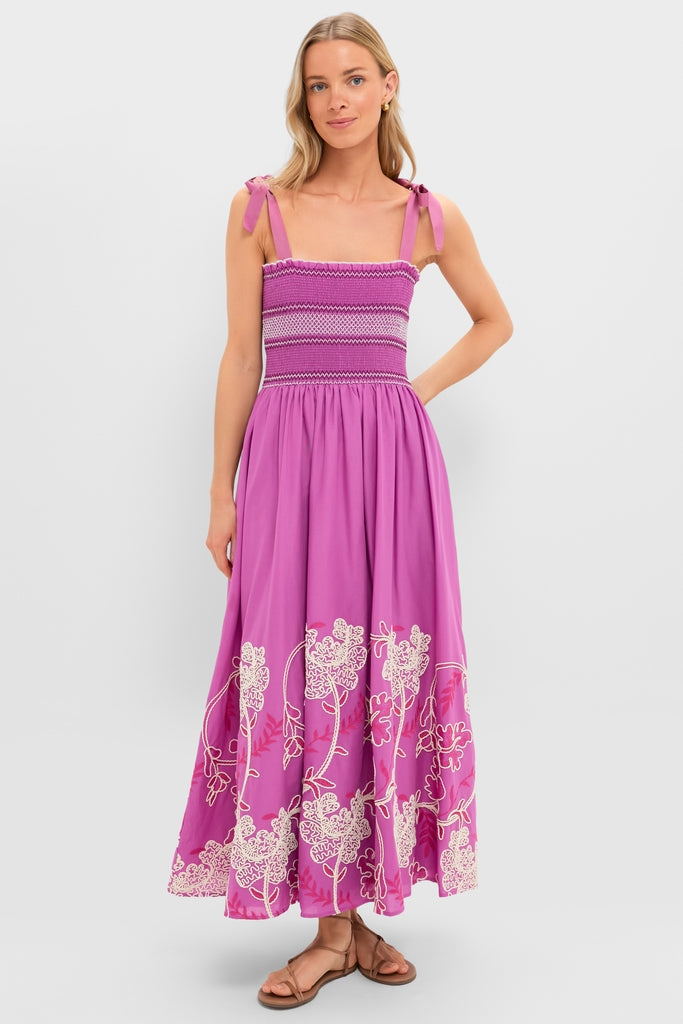 Model in classic Hibiscus Embroidered Scarlett Sundress, featuring a ruched bodice, flowy skirt with floral embroidery, and adjustable bow straps, paired with brown sandals. Effortless and high-end style.