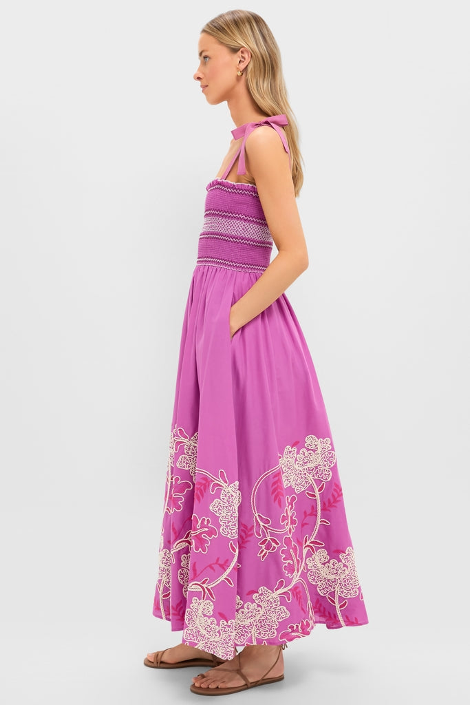 Model in profile wearing the Hibiscus Embroidered Scarlett Sundress with a classic ruched bodice, effortless flowy skirt, and fun eyelet details, embodying Tuckernuck's high-end style.