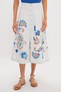 Folk Flower Embroidered Sadie Skirt: A classic A-line midi with effortless paisley embroidery, fun zig-zag trim, and high-end details, paired with tan toe-loop sandals.