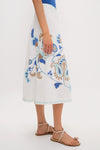 Folk Flower Embroidered Sadie Skirt: A classic, high-end, calf-length skirt with blue and tan floral embroidery, offering an effortless and fun style for any occasion.