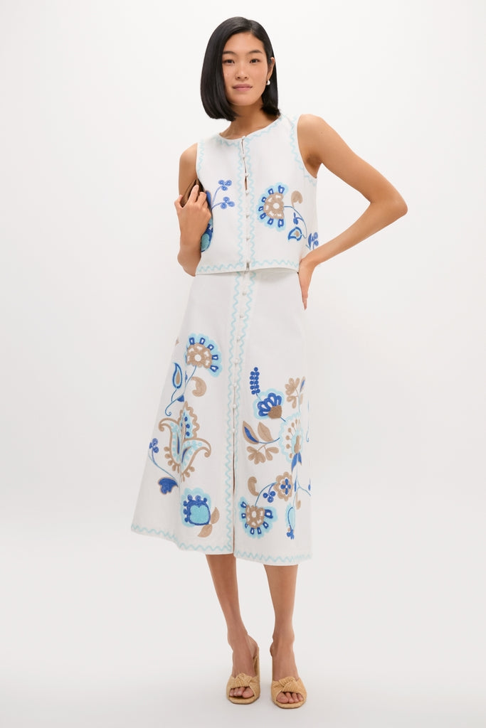 Model in a classic, high-end Folk Flower Embroidered Sadie Skirt set, showcasing effortless style with fun floral and paisley embroidery, paired with woven heeled sandals.