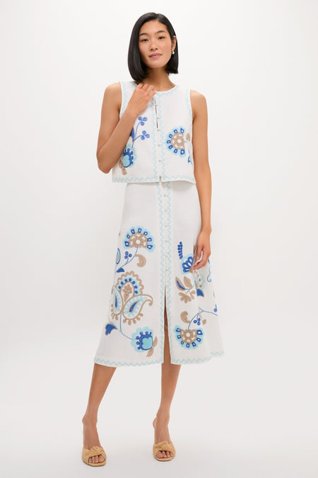 Folk Flower Embroidered Sadie Skirt ensemble features a classic, effortless style with fun floral motifs, paired with high-end straw-look sandals for a chic, confident look.