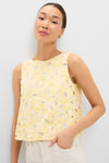 Woman modeling the Pale Yellow Flower Vera Top, a classic, sleeveless boxy lace top with daisy patterns, exuding effortless fun and high-end style.