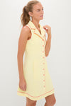 Model wearing the Lemon Yellow Georgia Golf Dress, a classic and effortless sleeveless design with pink piping, notched collar, and button-front, embodying high-end, fun style.
