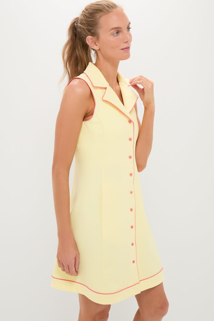 Model wearing the Lemon Yellow Georgia Golf Dress, a classic and effortless sleeveless design with pink piping, notched collar, and button-front, embodying high-end, fun style.
