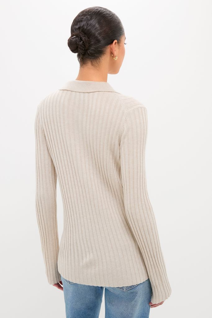 Back view of a person wearing the classic Sandstone Fine Rib Knit Button Down Myers Polo, offering an effortless, high-end look, paired with blue jeans.