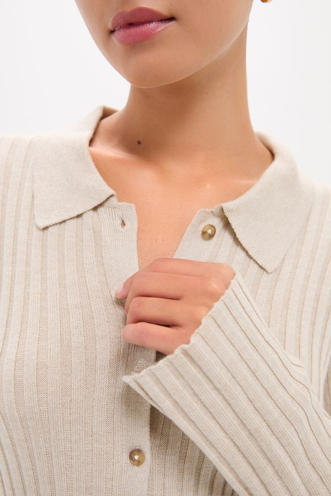 Woman wearing Sandstone Fine Rib Knit Button Down Myers Polo, showcasing its classic, high-end design with a small collar and buttons, creating an effortless, fun style.