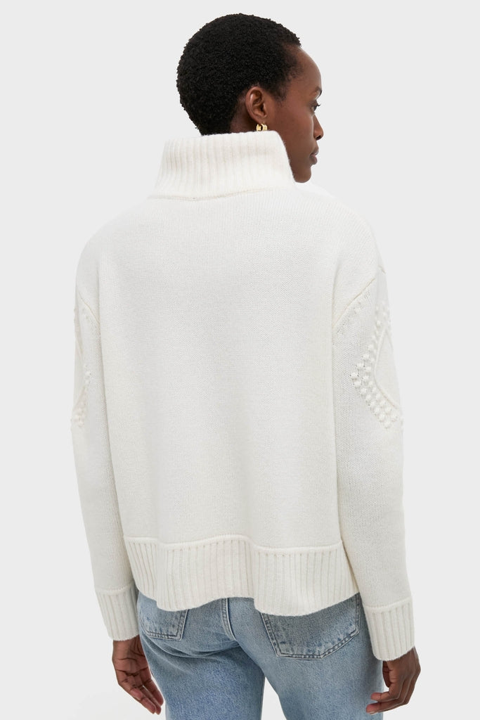Ivory Henry Button-Up Sweater exudes classic elegance with its relaxed fit, textured detailing, and ribbed finishes, offering an effortless, high-end winter look.