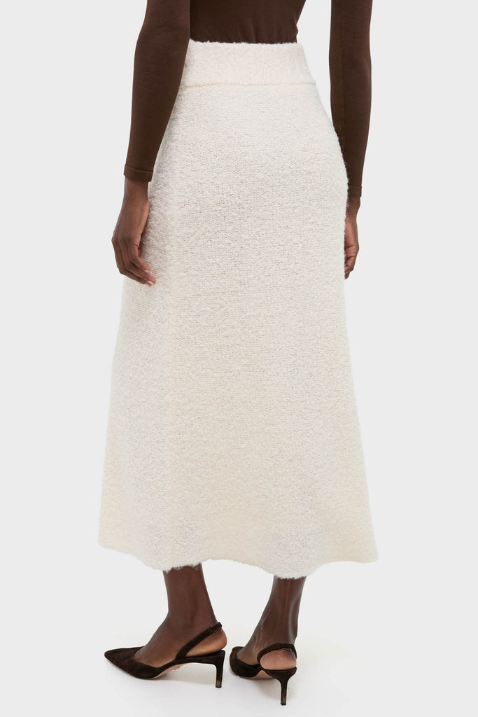 Effortless elegance with the Ivory Boucle Lillia Sweater Skirt, featuring a classic A-line silhouette and textured knit for a high-end, fun winter look.