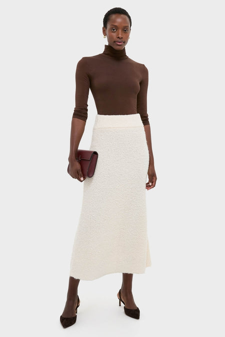Classic and effortless, the Ivory Boucle Lillia Sweater Skirt showcases a high-end, fun style with its plush texture and elegant, streamlined silhouette.