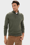 Man in Olive Green Cashmere Wool Button-Up sweater with three-button placket, paired effortlessly with tan pants, embodies a classic, high-end style. Perfect for fun, cool-weather occasions.