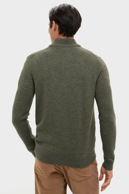 Olive Green Cashmere Wool Button-Up sweater with ribbed trim, seen from the back, paired with tan pants. Its classic, high-end design offers effortless winter style.