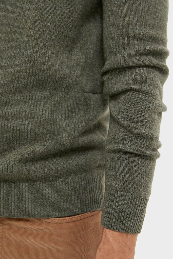 Classic Olive Green Cashmere Wool Button-Up sweater showcased with ribbed cuffs and hem, paired effortlessly with light brown corduroy trousers, embodying high-end comfort and style.