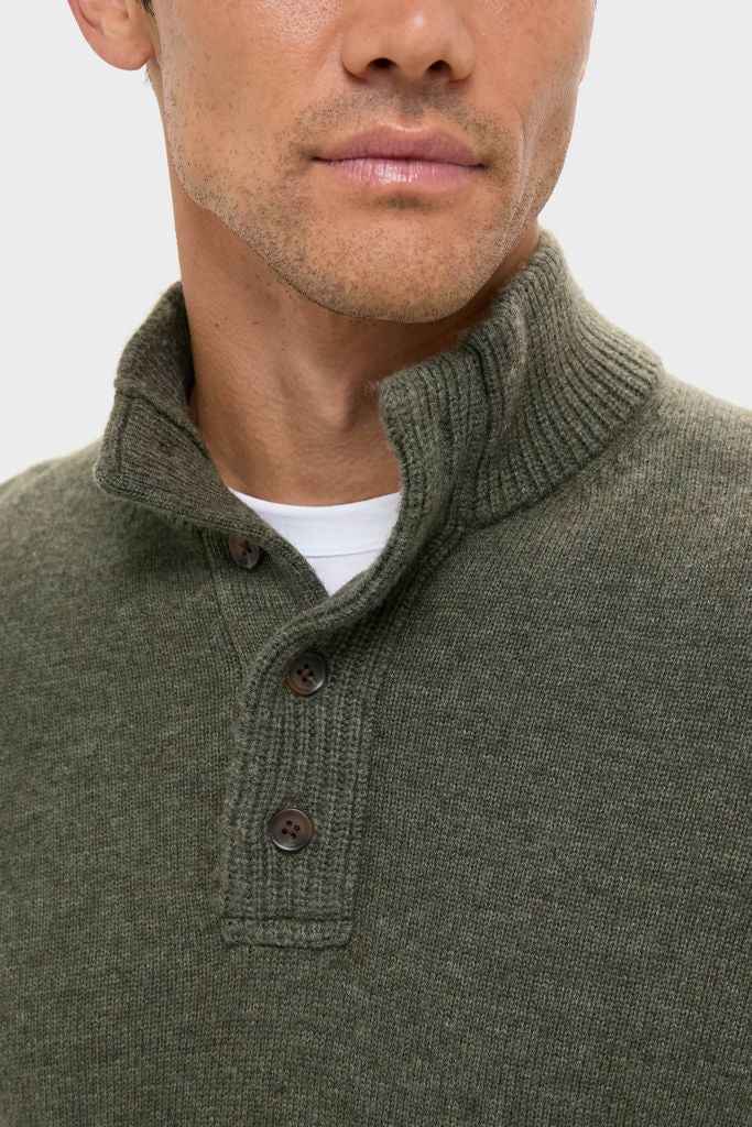 Man wearing the classic Olive Green Cashmere Wool Button-Up with a ribbed high collar and button placket, offering an effortless and high-end winter look.