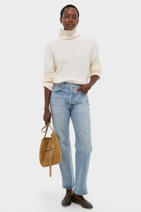 Model in classic Ivory Boucle Whilden Sweater Top, showcasing effortless style with ribbed finishes and relaxed fit, paired with jeans and dark flats for a high-end, fun look.