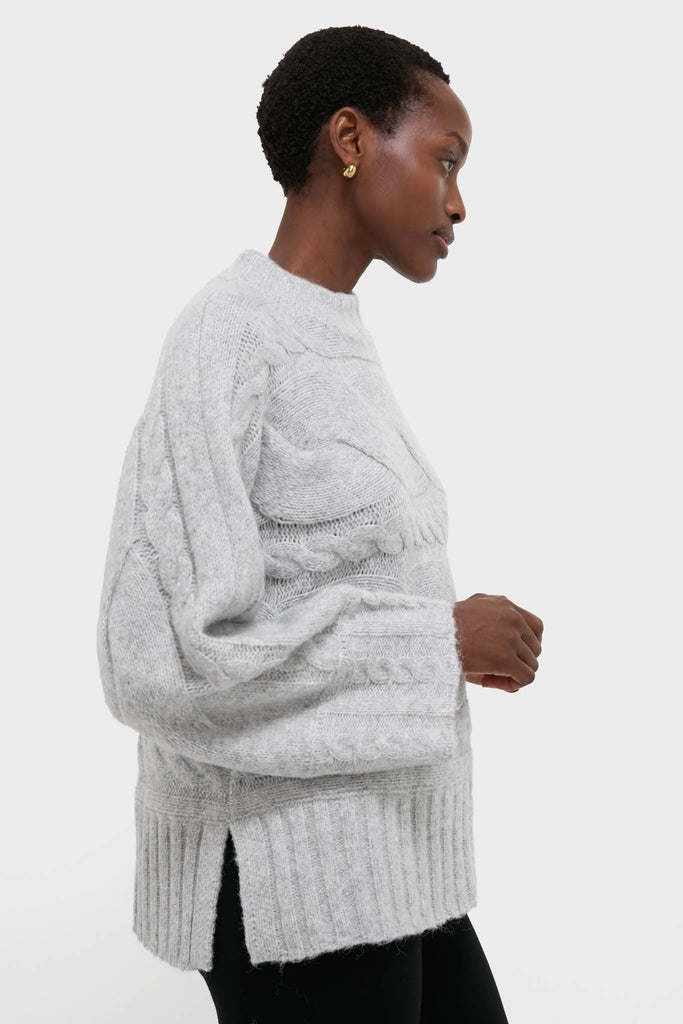 Gray Cableknit Gladwyn Sweater with classic cable-knit panels, balloon sleeves, and mock neck. Effortlessly chic and fun, perfect for a high-end, confident look.