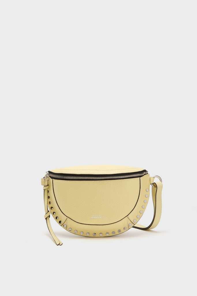 Butter Skano Fannypack: A classic, high-end crossbody bag featuring a half-moon shape with a top zipper, adjustable strap, and decorative metal studs for an effortless, fun style.