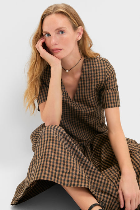 Woman in a classic, effortless Tobacco Brown Crinkled Taffeta Check Long Dress with V-neck and short sleeves, embodying a high-end, fun style.