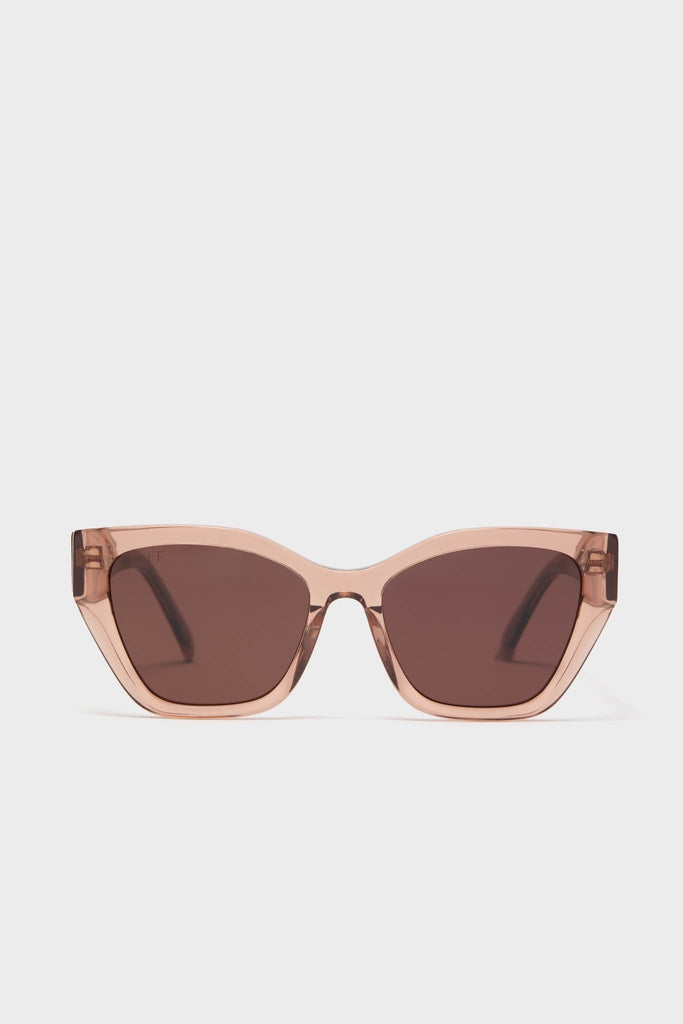 Cafe Ole Evie Polarized Sunglasses with classic cat-eye design, translucent blush-pink acetate frame, and brown-tinted lenses offer an effortless, fun, high-end look for sunny days.